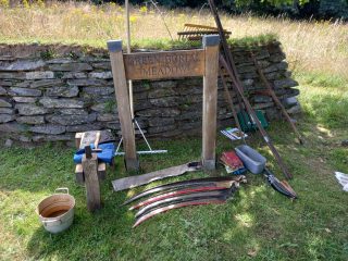 Green Burial Meadow Entrance with Scything Equipment